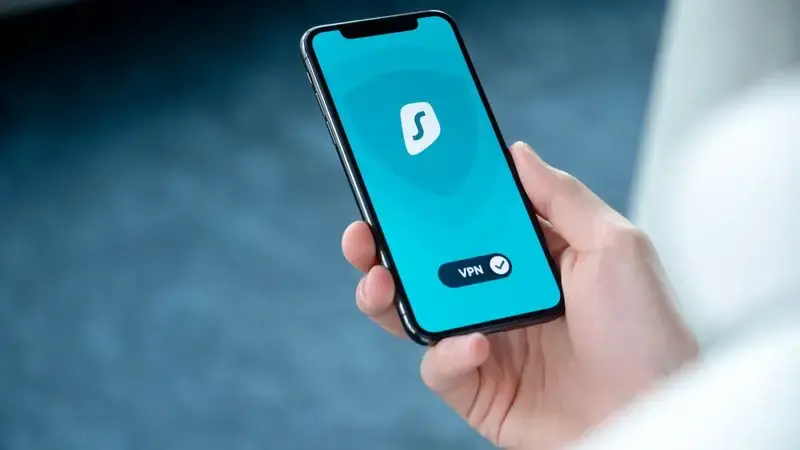 Hand holding a smartphone with chat bubble icons representing interests
